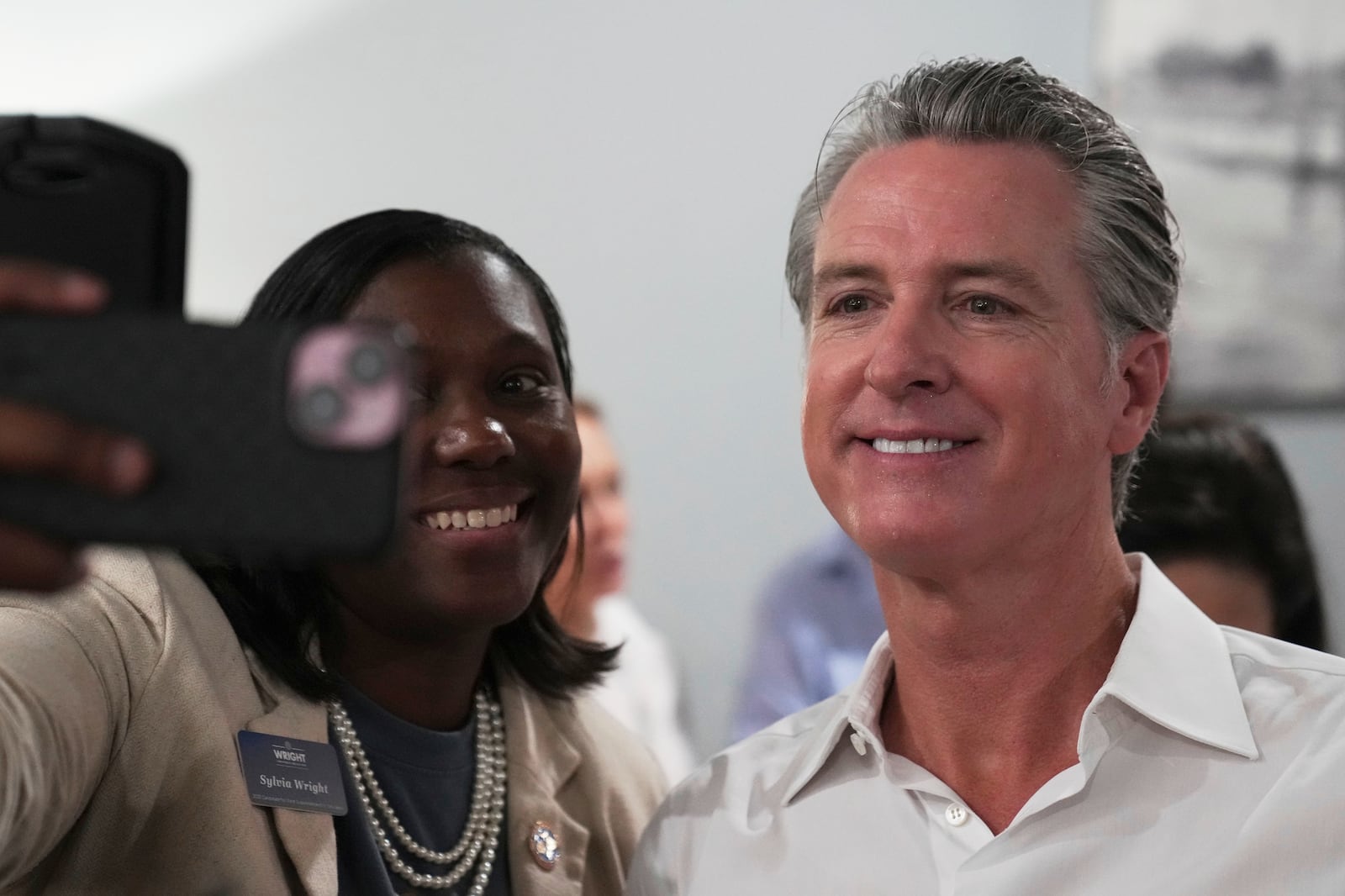 Gov. Gavin Newsom, D-Calif., greets people in a coffee shop during a two-day swing through South Carolina on Tuesday, July 8, 2025, in Florence, S.C. (AP Photo/Meg Kinnard)