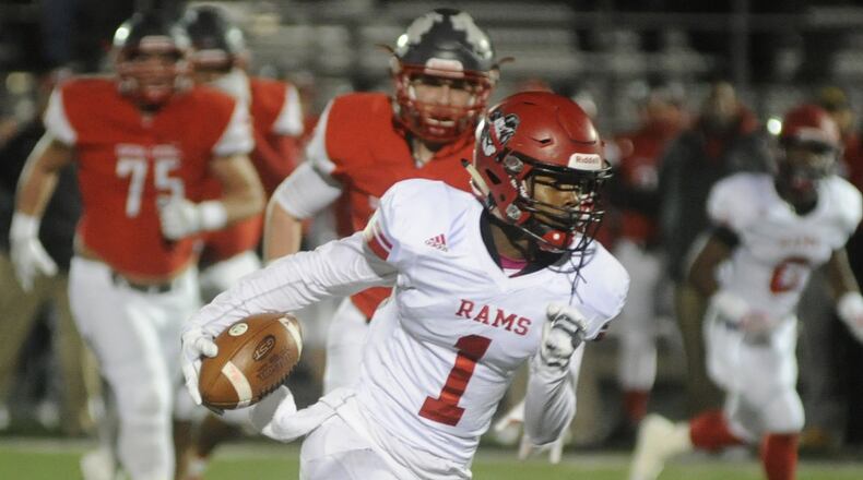 Trotwood’s Caleb Johnson makes a long run during 36-0 defeat of Toledo Central Catholic in a D-III high school football state semifinal at Lima last November. MARC PENDLETON / STAFF