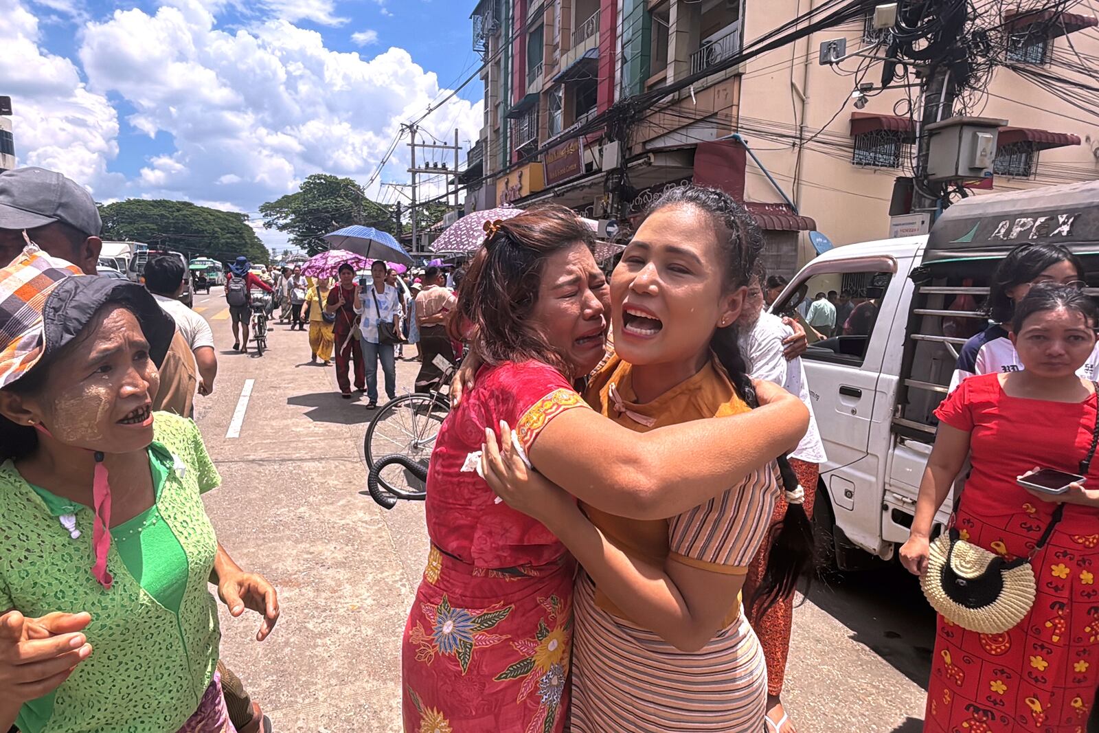A released prisoner, center right, is welcomed by family members outside the main gate of Insein prison as the head of Myanmar’s military government granted amnesty to thousands of prisoners to mark the country's traditional New Year Thursday, April 17, 2025, in Yangon, Myanmar. (AP Photo/Thein Zaw)
