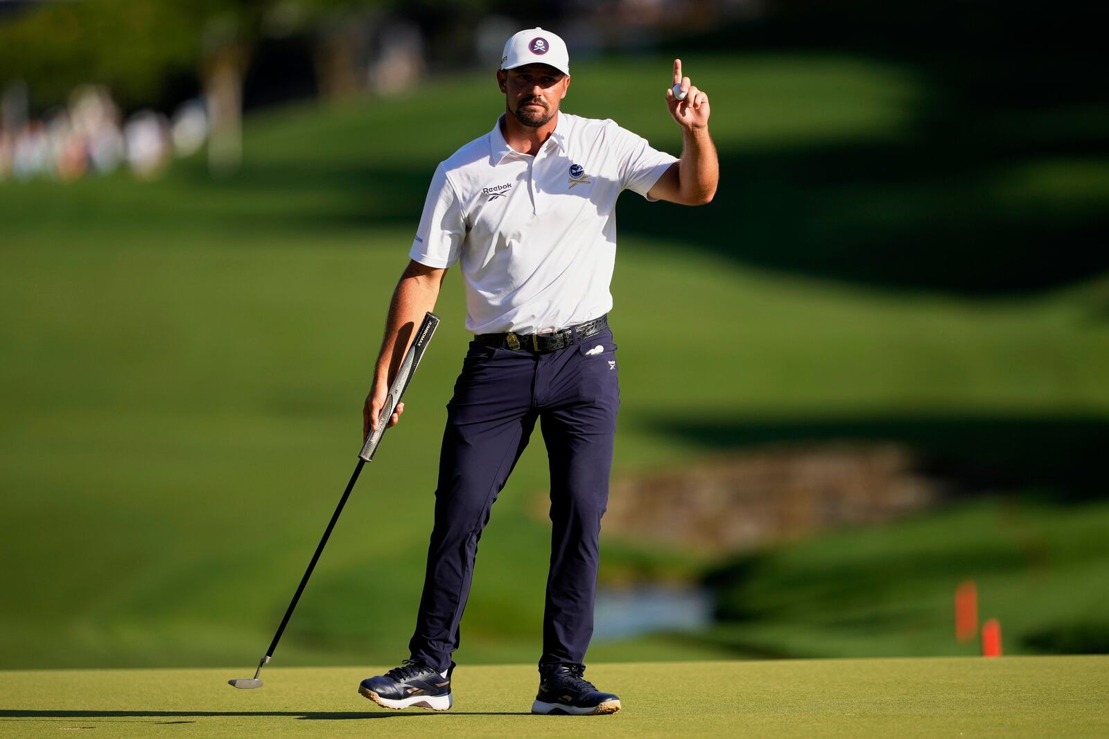 Bryson DeChambeau waves on the 18th hole during the third round of the PGA Championship golf tournament at the Quail Hollow Club, Saturday, May 17, 2025, in Charlotte, N.C. (AP Photo/Matt York)