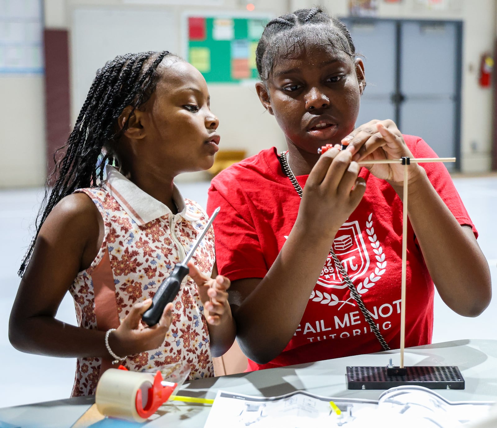 A student and a counselor in Fail Me Not Tutoring work on a windmill project on Wednesday, July 23 at the summer camp, which was held at Trotwood Preparatory and Fitness Academy property. BRYANT BILLING / STAFF