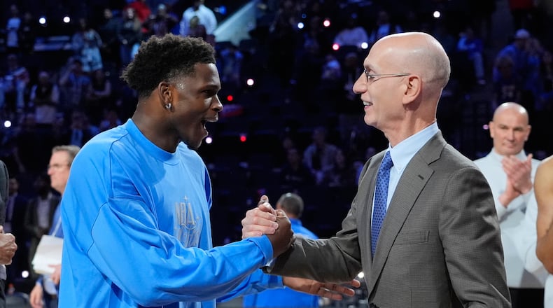 USA Stars guard Anthony Edwards, left, shakes hands with commissioner Adam Silver after the NBA All-Star basketball game Sunday, Feb. 15, 2026, in Inglewood, Calif. (AP Photo/Jae C. Hong)