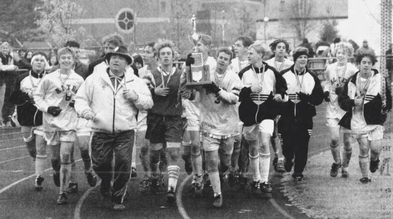 Alter boys soccer coach Bob Ellis, front left, celebrates with the team after winning the 1996 state championship. Staff photo by Skip Peterson