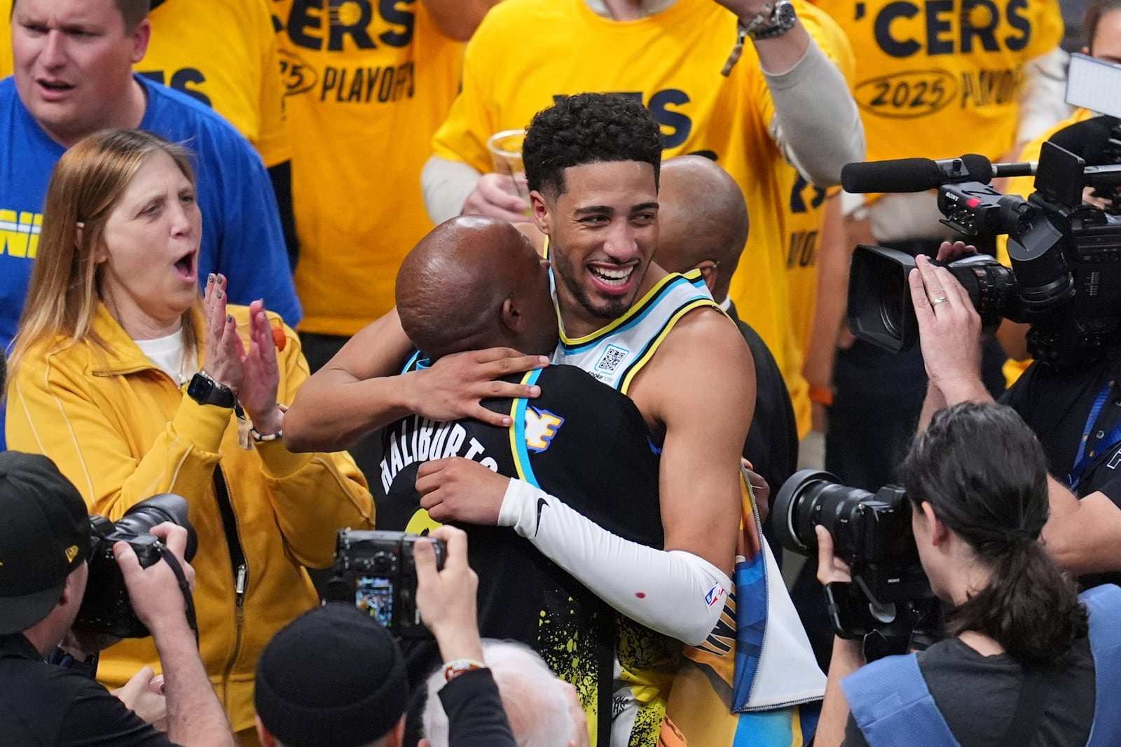 Indiana Pacers guard Tyrese Haliburton (0) hugs his father John Haliburton following Game 5 of an NBA basketball first-round playoff series against the Milwaukee Bucks, Tuesday, April 29, 2025, in Indianapolis. (AP Photo/Michael Conroy)