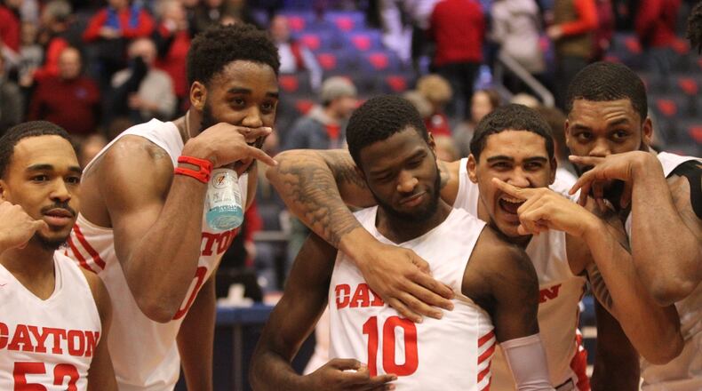 Dayton players pose for a photo after a victory against La Salle on Wednesday, March 6, 2019, at UD Arena. David Jablonski/Staff