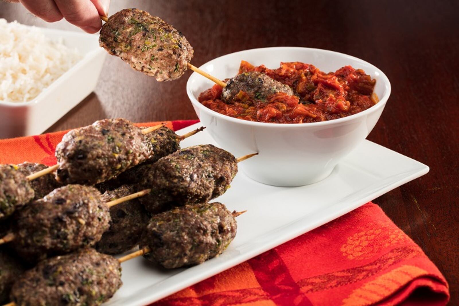 The lamb and Kalamata olive sausages are formed by hand then skewered for cooking. Serve them with a minted tomato sauce. (Zbigniew Bzdak/Chicago Tribune/TNS)
