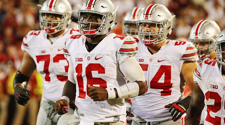 NORMAN, OK - SEPTEMBER 17: J.T. Barrett #16 of the Ohio State Buckeyes walks with his offense off the field in the second half of their game against the Oklahoma Sooners at Gaylord Family Oklahoma Memorial Stadium on September 17, 2016 in Norman, Oklahoma. (Photo by Scott Halleran/Getty Images)