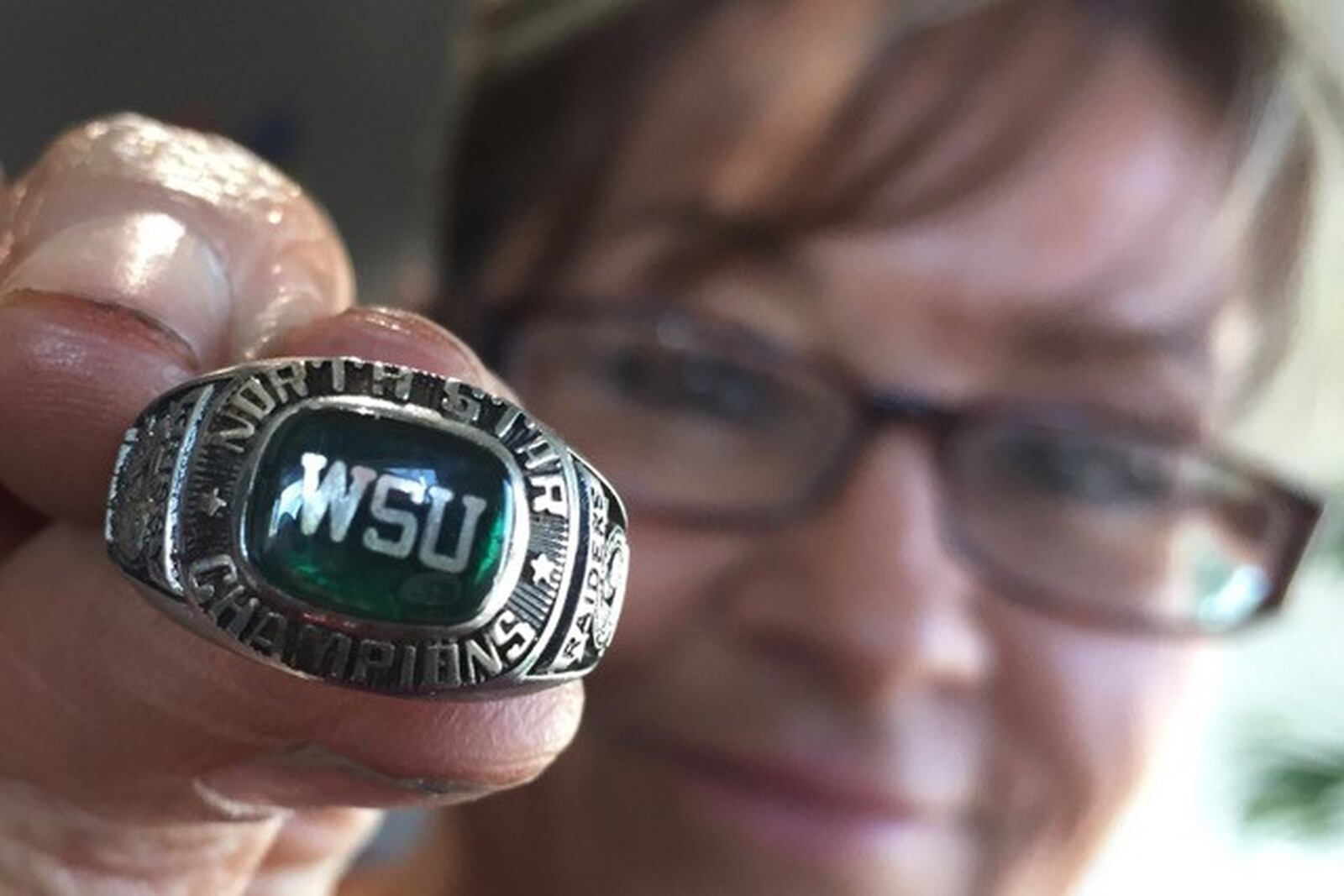 Sheila Logan of Hampton. Va. holds the Wright State swimming championship ring lost by Krissy Fott Randall in Florida in 1993. A family member of Logan’s found the ring in the beach sand in Clearwater soon after. Logan got the ring three years ago from her step-daughter and diligently searched for the unknown owner through social media. The connection was finally made in late November and the ring returned to Ohio for the first time in 23 years. PHOTO COURTESY OF THE DAILY PRESS.