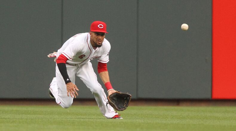 Reds center fielder Billy Hamilton dives but can’t catch a line drive against the Brewers on Friday, April 14, 2017, at Great American Ball Park in Cincinnati. David Jablonski/Staff