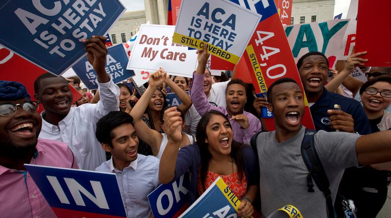 Students cheer as they hold up signs outside of the Supreme Court in Washington, D.C, supporting the Affordable Care Act. Republican foes of President Barack Obama’s signature health reform law have already begun taking steps to repeal it. AP Photo