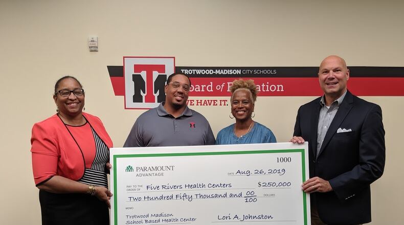 Dayton-based Five Rivers Health Centers, said today that it was awarded a $500,000 grant from Paramount Advantage, a Mediciad insurance plan privately managed by Toledo-based ProMedica. From left, Gina McFarlane-El, CEO, Five Rivers Health Centers; Marlon Howard, Acting Superintendent, Trotwood Madison Schools; Janice Allen, Treasurer, Trotwood Madison Schools; and Tim Petee, Director-Regional Operations, Paramount Healthcare.