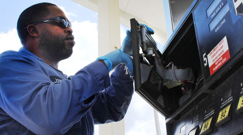 Joseph Harris, chief inspector with the Montgomery County Auditor office’s weights and measures division, checks a gas pump for skimmers at Clark gas station on Old Troy Pike. CORNELIUS FROLIK / STAFF