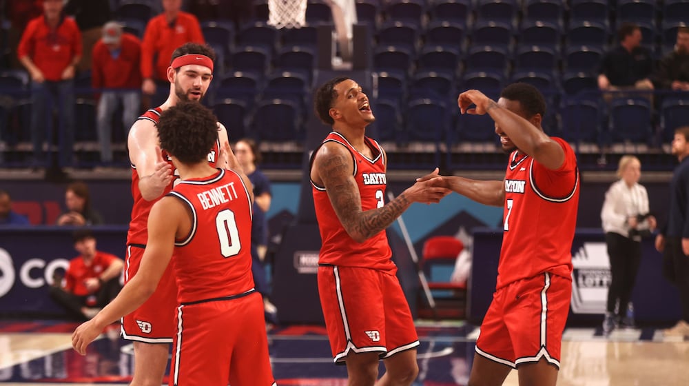 Dayton players celebrate after a victory against Duquesne on Tuesday, Jan. 13, 2026, at the UPMC Cooper Fieldhouse in Pittsburgh. David Jablonski/Staff