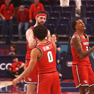 Dayton players celebrate after a victory against Duquesne on Tuesday, Jan. 13, 2026, at the UPMC Cooper Fieldhouse in Pittsburgh. David Jablonski/Staff