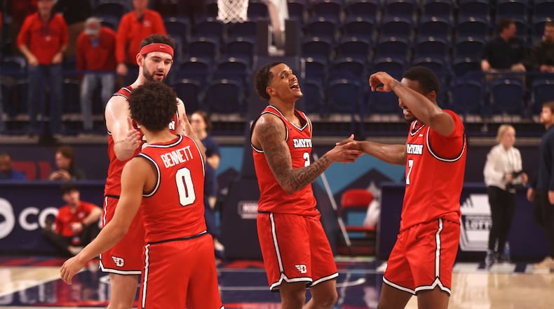 Dayton players celebrate after a victory against Duquesne on Tuesday, Jan. 13, 2026, at the UPMC Cooper Fieldhouse in Pittsburgh. David Jablonski/Staff