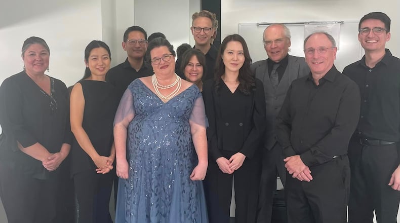 Soprano Andrea Chenowith Wells (in blue dress) pictured with ensemble after a recital.