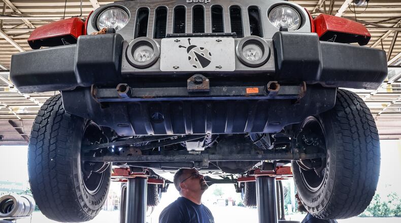 Jamie's Tire & Service manager, Rob Leach, left, and Technician James Wellman work on Jeep Friday afternoon June 24, 2022. The business will participate in Wednesday's summer job fair at Wright State University's Nutter Center. JIM NOELKER/STAFF