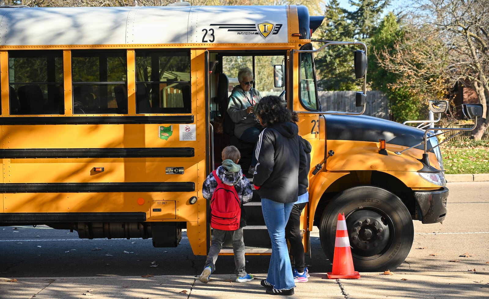 A student walks onto a school bus on Monday, Nov. 17, at Oakview Elementary School in Kettering. BRYANT BILLING/STAFF