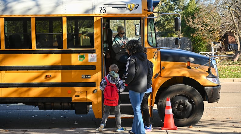 A student walks onto a school bus on Monday, Nov. 17, at Oakview Elementary School in Kettering. BRYANT BILLING/STAFF