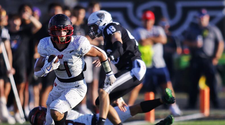 Lakota West's Trent Lloyd looks for room to run during Friday night's game at Lakota East. Nick Graham/STAFF
