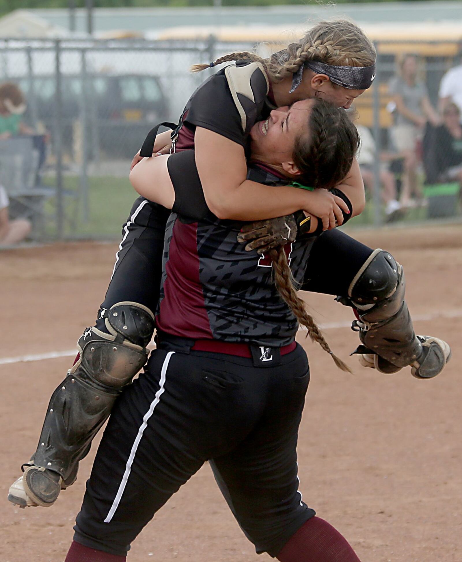 Lebanon pitcher Alexis Strother lifts up catcher Molly Osborne in celebration Sunday after the Warriors captured a Division I regional championship with a 7-3 win over Mason at Kings. CONTRIBUTED PHOTO BY E.L. HUBBARD