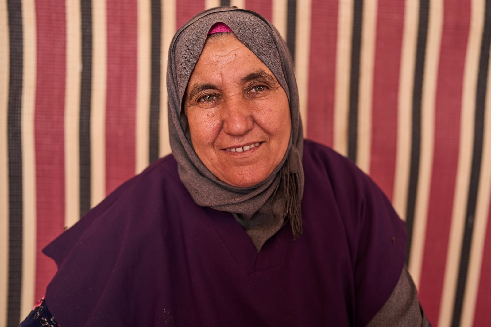 Kharra Tlaytmass, who works at a cooperative that extracts and produces argan oil and products, poses for a portrait, Essaouira, Morocco, Thursday, May 22, 2025. (AP Photo/Mosa'ab Elshamy)