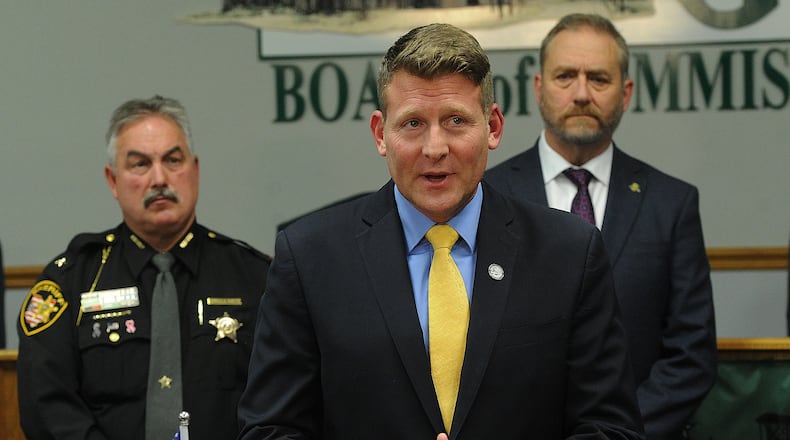 Greene County Prosecutor David Hayes, along with Greene County Sheriff Scott Anger (left) and Ohio Attorney General Dave Yost (right), detail the criminal case against former Yellow Springs doctor Donald Gronbeck Monday, Oct. 24, 2022. Gronbeck has been charged with 50 counts, including rape, sexual battery, and gross sexual imposition against patients under his care. MARSHALL GORBY\STAFF