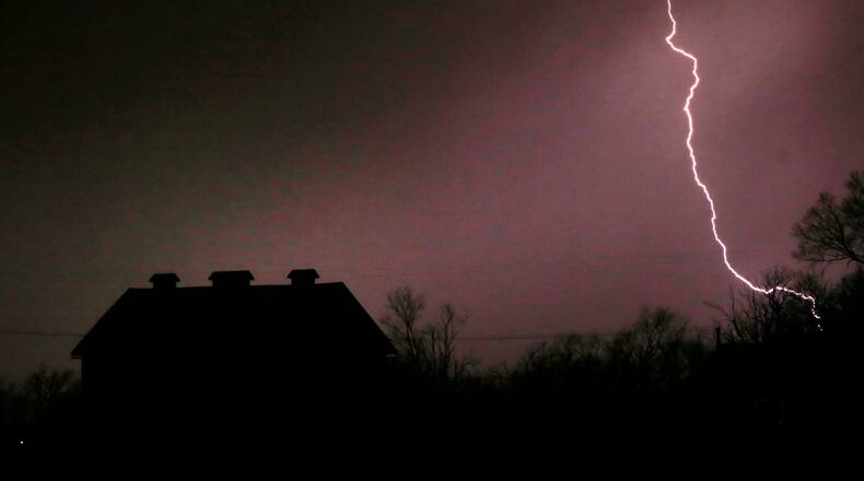 FILE - In this March 6, 2017 file photo, lightning strikes near the barn on the Taylor farm near Lawrence, Kan. Lightning used to kill about 300 Americans a year, but lightning deaths are on pace to hit a record low this year. Scientists say less time spent outside and improved medical treatment have contributed to fewer deaths. (AP Photo/Orlin Wagner, File)