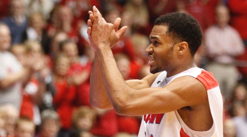 Dayton guard Vee Sanford acknowledges the crowd's cheers as he leaves the game for the final time on Senior Night on Saturday, March 8, 2014, at UD Arena. David Jablonski/Staff