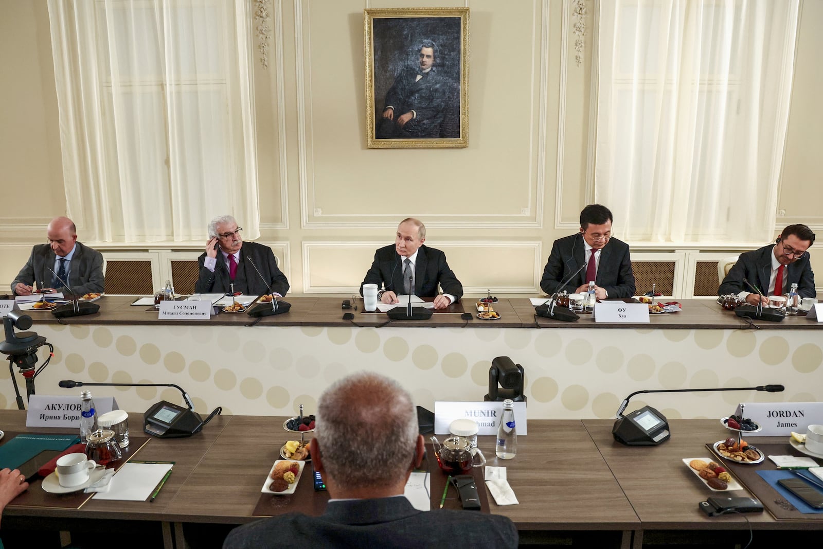 Russian President Vladimir Putin, center, meets with the heads of international news agencies at the newly renovated St. Petersburg Rimsky-Korsakov State Conservatory on the sidelines of the St. Petersburg International Economic Forum in St. Petersburg, Russia, Wednesday, June 18, 2025. (, Sputnik, Kremlin Pool Photo via AP)