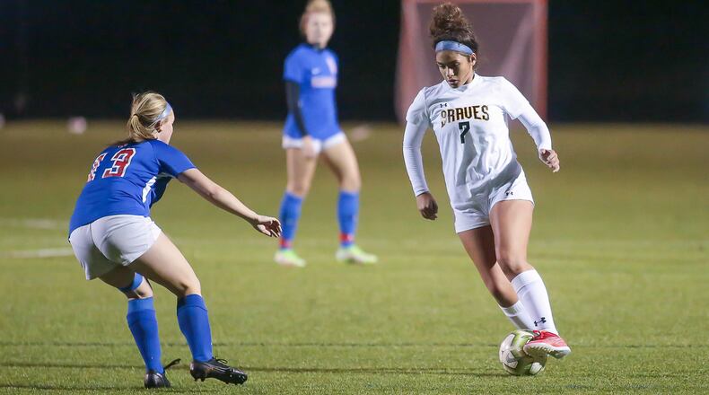 Shawnee High School junior Juliana Cydrus dribbles the ball asCarroll's Brooke Grieshop defends during their game on Monday night at Fairmont High School. The Patriots won 2-0