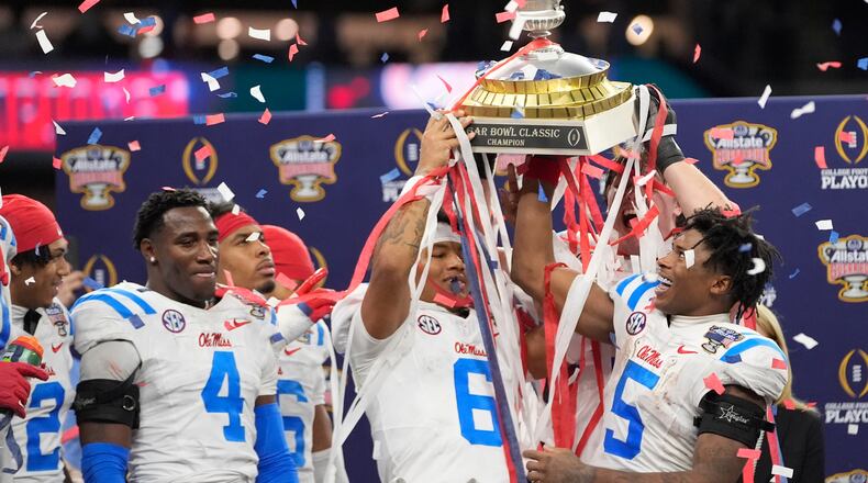 Mississippi platers and coach celebrate a win against Georgia after the Sugar Bowl NCAA college football playoff quarterfinal game, Friday, Jan. 2, 2026, in New Orleans. (AP Photo/Gerald Herbert)