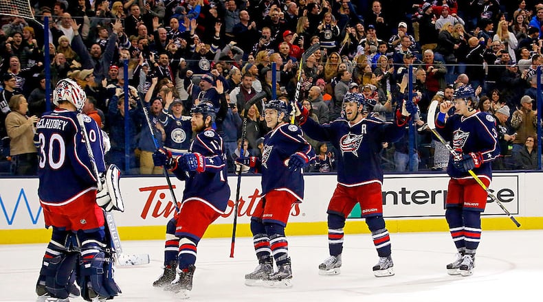 COLUMBUS, OH - DECEMBER 20: Curtis McElhinney #30 of the Columbus Blue Jackets is congratulated by his teammates after defeating the Los Angeles Kings 3-2 in a shootout on December 20, 2016 at Nationwide Arena in Columbus, Ohio. (Photo by Kirk Irwin/Getty Images)