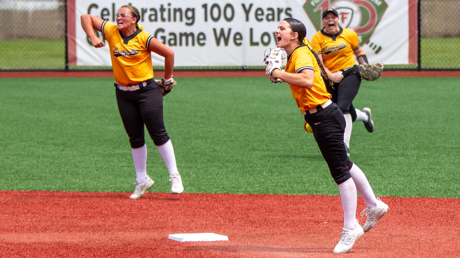 Centerville sophomore Natalie Carr (foreground right) celebrates with teammates Chayse Adkins (left) and Olivia Castle after she caught a low popup and stepped on second base to end the first inning with a double play. Jeff Gilbert/CONTRIBUTED