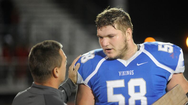 Miamisburg sr. OL Josh Myers accepts a regional runner-up trophy. Cincinnati La Salle defeated Miamisburg 45-14 in a D-II, Region 8 high school football final at Mason on Friday, Nov. 18, 2016. MARC PENDLETON / STAFF