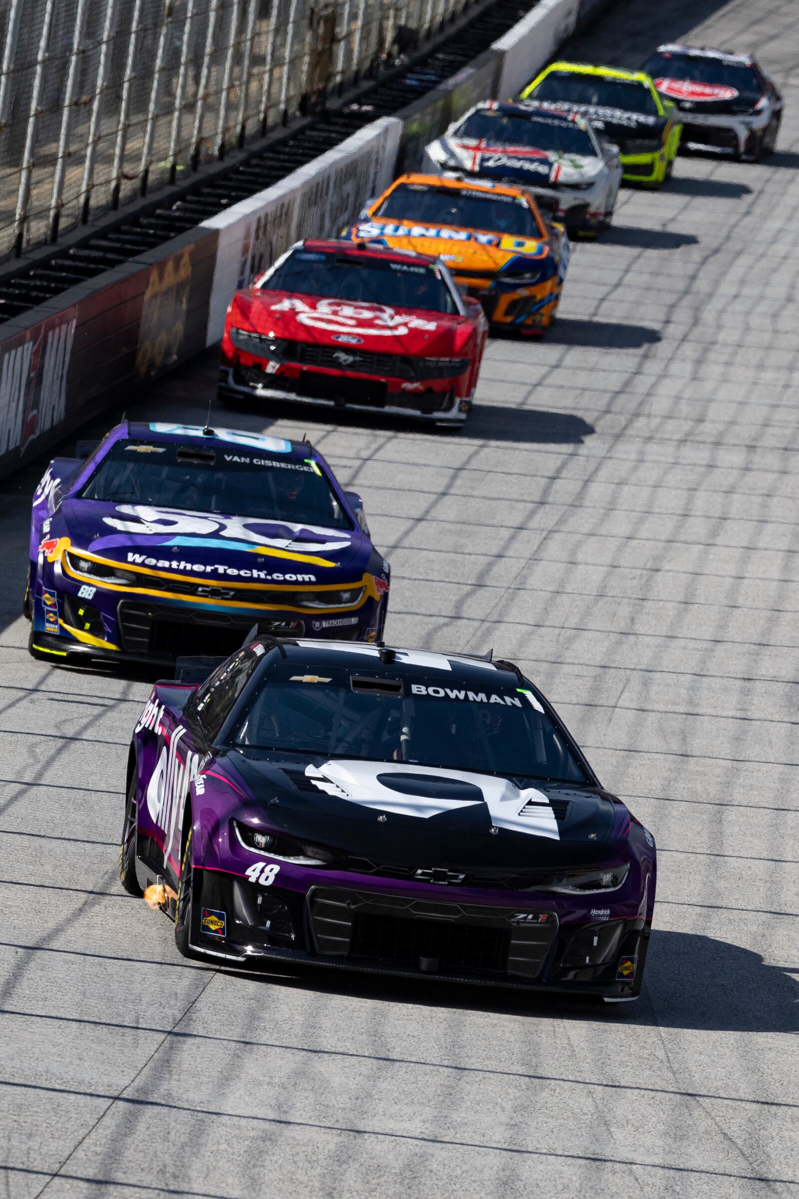 Alex Bowman (48) leads Shane van Gisbergen (88) and others during a NASCAR Cup Series auto race, Sunday, April 13, 2025, in Bristol, Tenn. (AP Photo/Wade Payne)