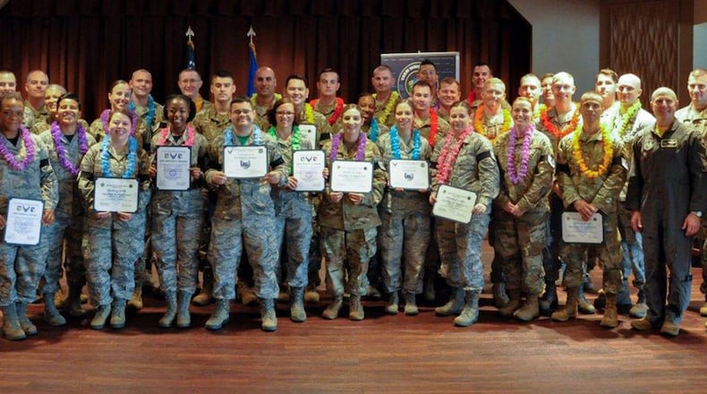 Col. Thomas Sherman (left), 88th Air Base Wing and installation commander, Maj. Gen. Carl Schaefer (second from right), deputy commander, Air Force Materiel Command, and Chief Master Sgt. Stanley Cadell (right), Air Force Materiel command chief, celebrate the newest Team Wright-Patt technical sergeant promotees at the Wright-Patterson Club July 19. (U.S. Air Force photo/Senior Airmen Holly Ardern)