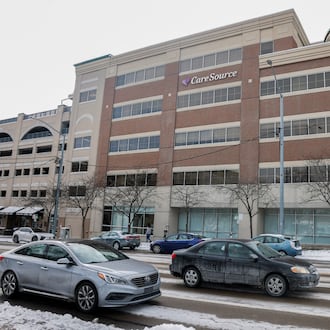 Vehicles drive past CareSource on Monday, Dec. 15, 2025, in downtown Dayton. JOSEPH COOKE/STAFF