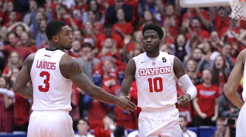 Dayton’s Jalen Crutcher, center, gets back on defense after making a 3-pointer against Davidson with 56 seconds to play on Tuesday, Jan. 23, 2018, at UD Arena. David Jablonski/Staff