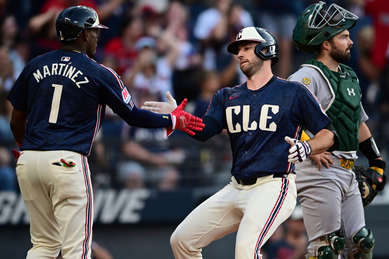 Cleveland Guardians' David Fry, right, is congratulated by Angel Martínez after hitting a two-run home run during the third inning of a baseball game, Friday, July 18, 2025, in Cleveland. (AP Photo/David Dermer)