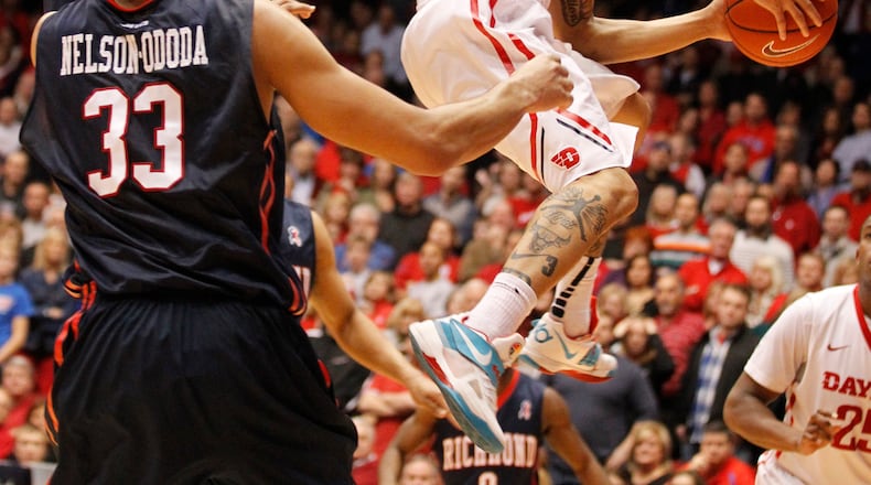 Dayton guard Kyle Davis scores on a layup with 19 seconds left as Richmond's Trey Davis, top left, and Alonzo Nelson-Ododa defend on Saturday, Jan. 24, 2015, at UD Arena. David Jablonski/Staff David Jablonski/Staff