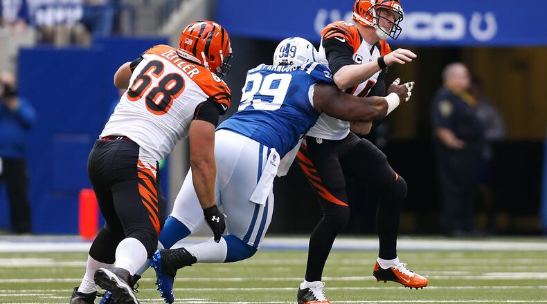 INDIANAPOLIS, IN - OCTOBER 19: Ricky Jean Francois #99 of the Indianapolis Colts slips past Kevin Zeitler #68 of the Cincinnati Bengals to hit Andy Dalton #14 of the Cincinnati Bengals during the third quarter on October 19, 2014 at Lucas Oil Stadium on October 19, 2014 in Indianapolis, Indiana. Indianapolis defeated Cincinnati 27-0. (Photo by Kirk Irwin/Getty Images)