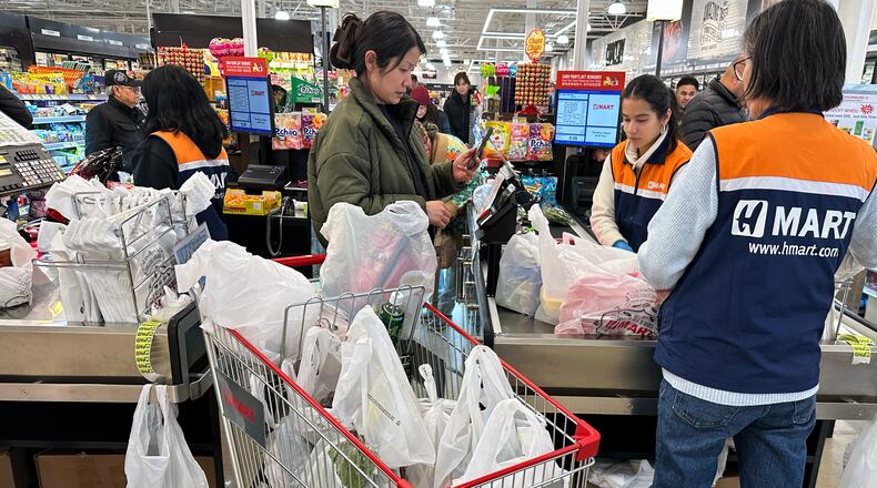 A shopper checks out at a cash register in a grocery store in Schaumburg, Ill., Monday, Feb. 9, 2026. (AP Photo/Nam Y. Huh)