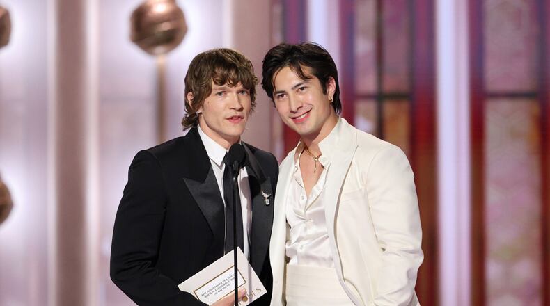 This image released by CBS Broadcasting shows presenters Connor Storrie and Hudson Williams, right, during the 83rd Golden Globes on Sunday, Jan. 11, 2026, at the Beverly Hilton in Beverly Hills, Calif. (Kevork Djansezian/CBS Broadcasting via AP)