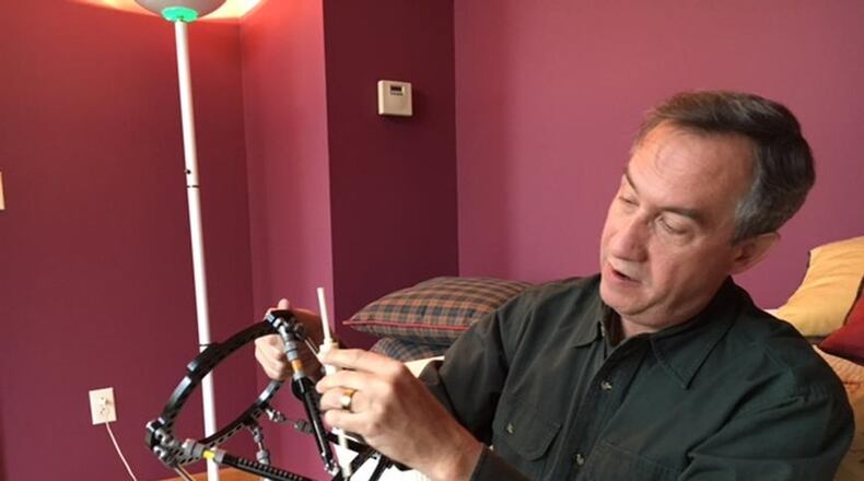 Tyson Ross, a Wright-Patterson Air Force base engineer, explains the automated growing rod he and colleague Casel Burnett have developed, pictured in a 2017 file photo. The rod can help growing children afflicted with scoliosis, they believe. THOMAS GNAU/STAFF