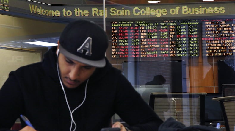 Wright State University student Aziz Almuhanna studies for final exams outside of the Soin Trading Center in Rike Hall. The surge in stocks after the presidential election has yielded record highs on 15 trading days. TY GREENLEES / STAFF