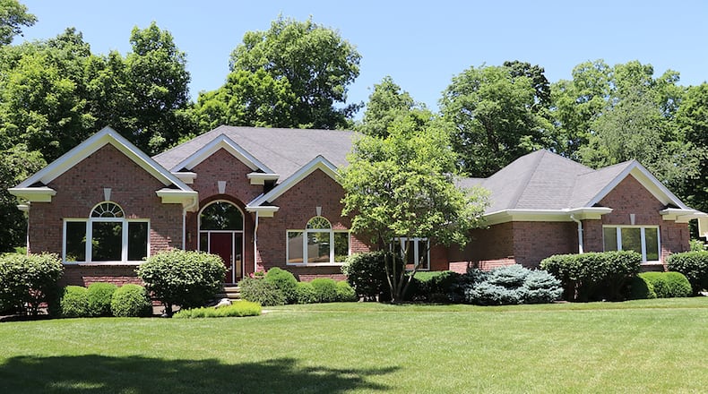 The brick ranch, custom built in 1999, offers about 5,660 sq. ft. of living space, and features an open split floor plan. The home also has a full, finished basement creating flexible living space. An extra parking pad is near the side-entry, 3-car garage. CONTRIBUTED PHOTO BY KATHY TYLER