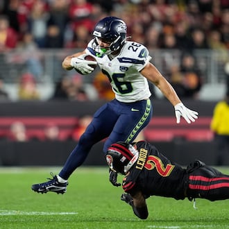 Seattle Seahawks running back Zach Charbonnet (26) runs against San Francisco 49ers cornerback Deommodore Lenoir (2) during the second half of an NFL football game in Santa Clara, Calif., Saturday, Jan. 3, 2026. (AP Photo/Godofredo A. Vásquez)