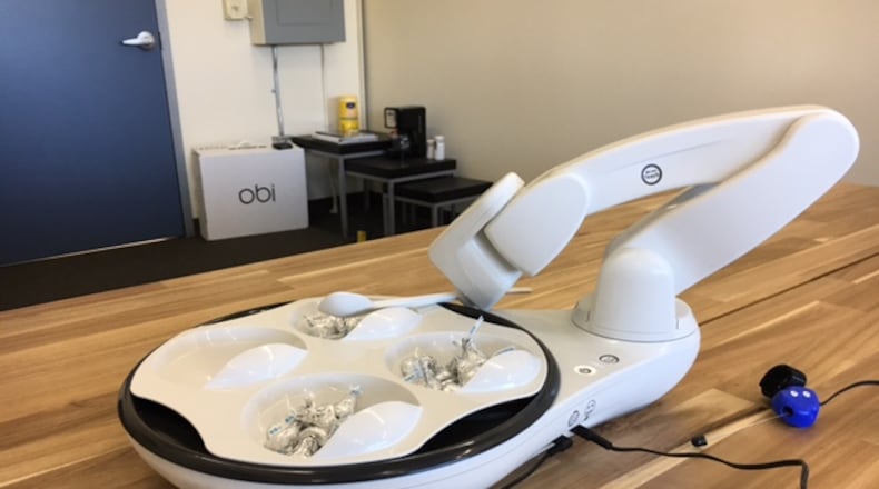 Meet Obi. Obi is a robot that can assist people with mobility impairments with eating. It can be programmed to lift a spoon laden with properly sized food portions to a person’s mouth. THOMAS GNAU/STAFF