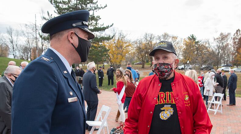 Col. Patrick Miller, 88th Air Base Wing and Wright-Patterson Air Force Base installation commander, visits with John Corbet, a U.S. Marine veteran who saw combat during the Korean War, following the Centerville Veterans Day observance Nov. 11. Corbet is a Centerville resident and attended the event where Miller was the feature speaker. U.S. AIR FORCE PHOTO/R.J. ORIEZ